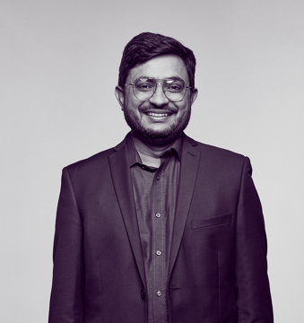 Dr Sabar, an oncologist, wearing a suit and smiling at the camera