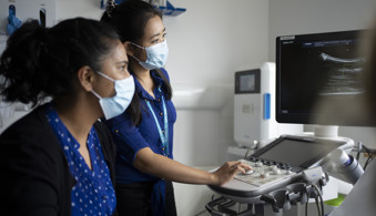 Trainee and consultant radiologists, conducting an ultrasound consultation